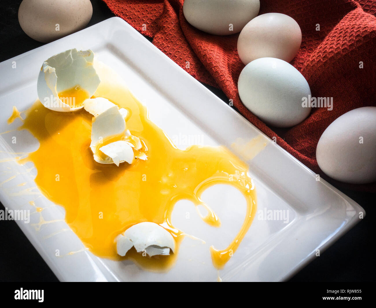 Broken Fresh Matrimony Egg on White Plate Stock Photo