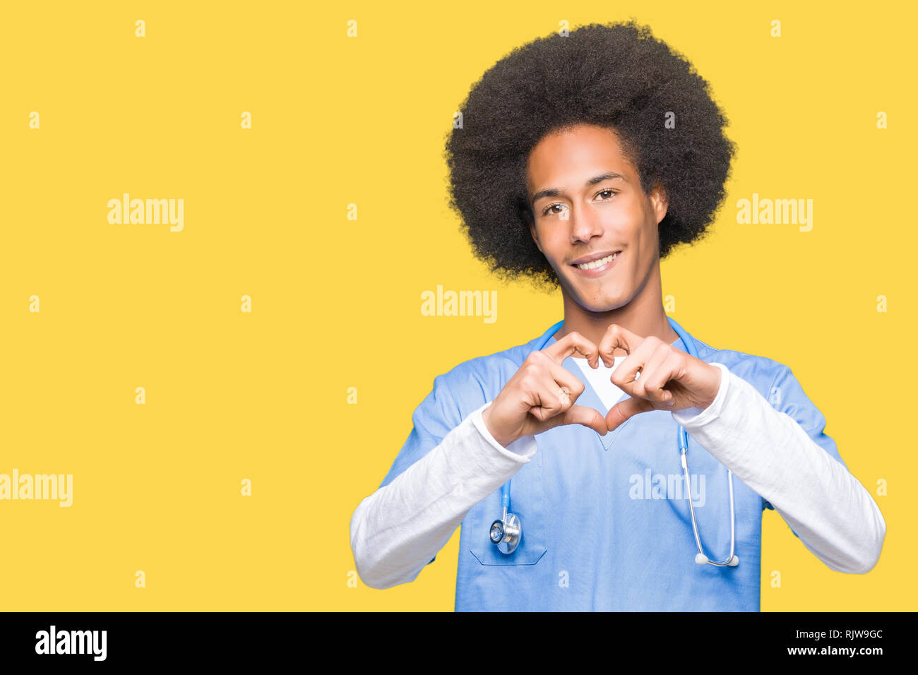 Young african american doctor man with afro hair smiling in love ...