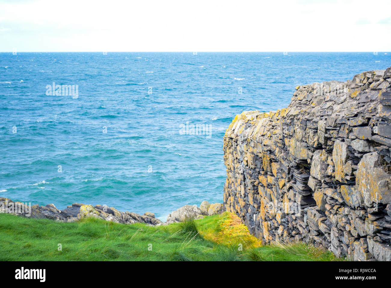 Great wall of Peel Castle up on St Patrick's Isle in city of Peel, Isle of Man Stock Photo