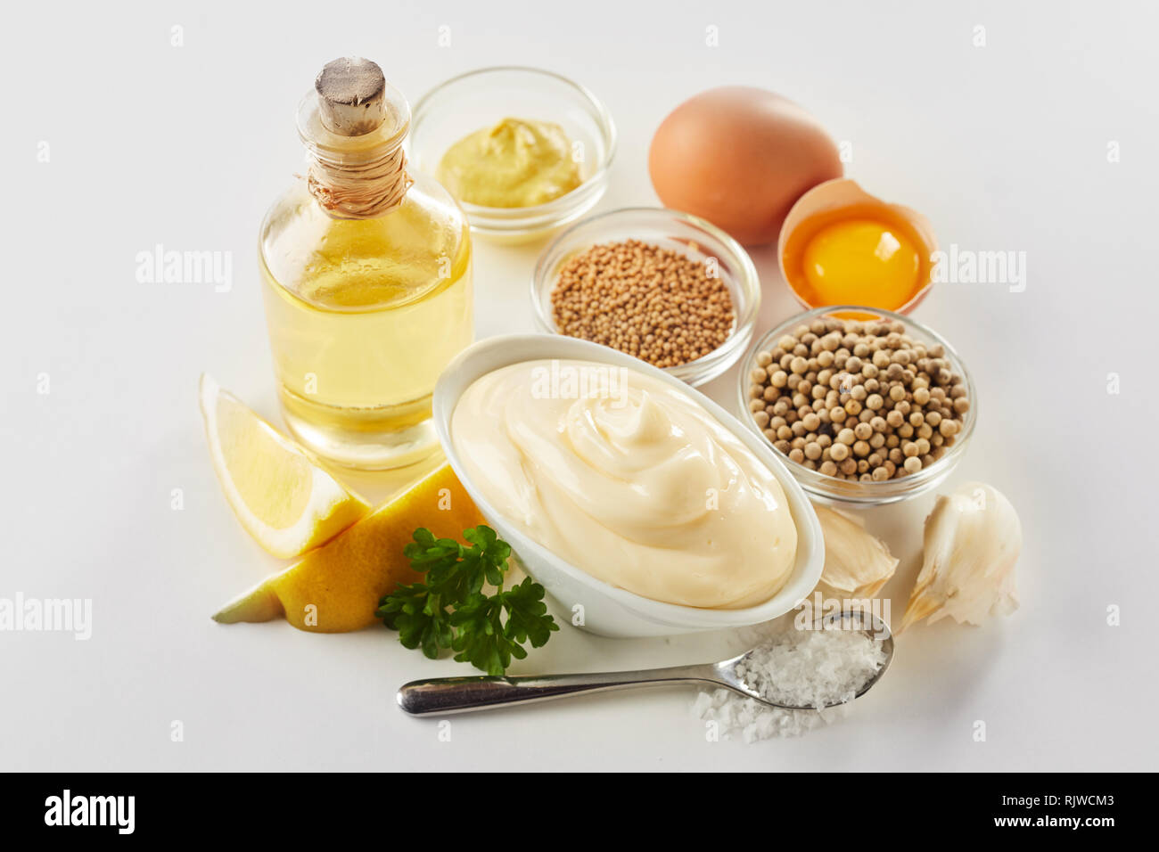 Recipe ingredients for gourmet homemade mayonnaise with egg yolks, oil, lemon and spices viewed