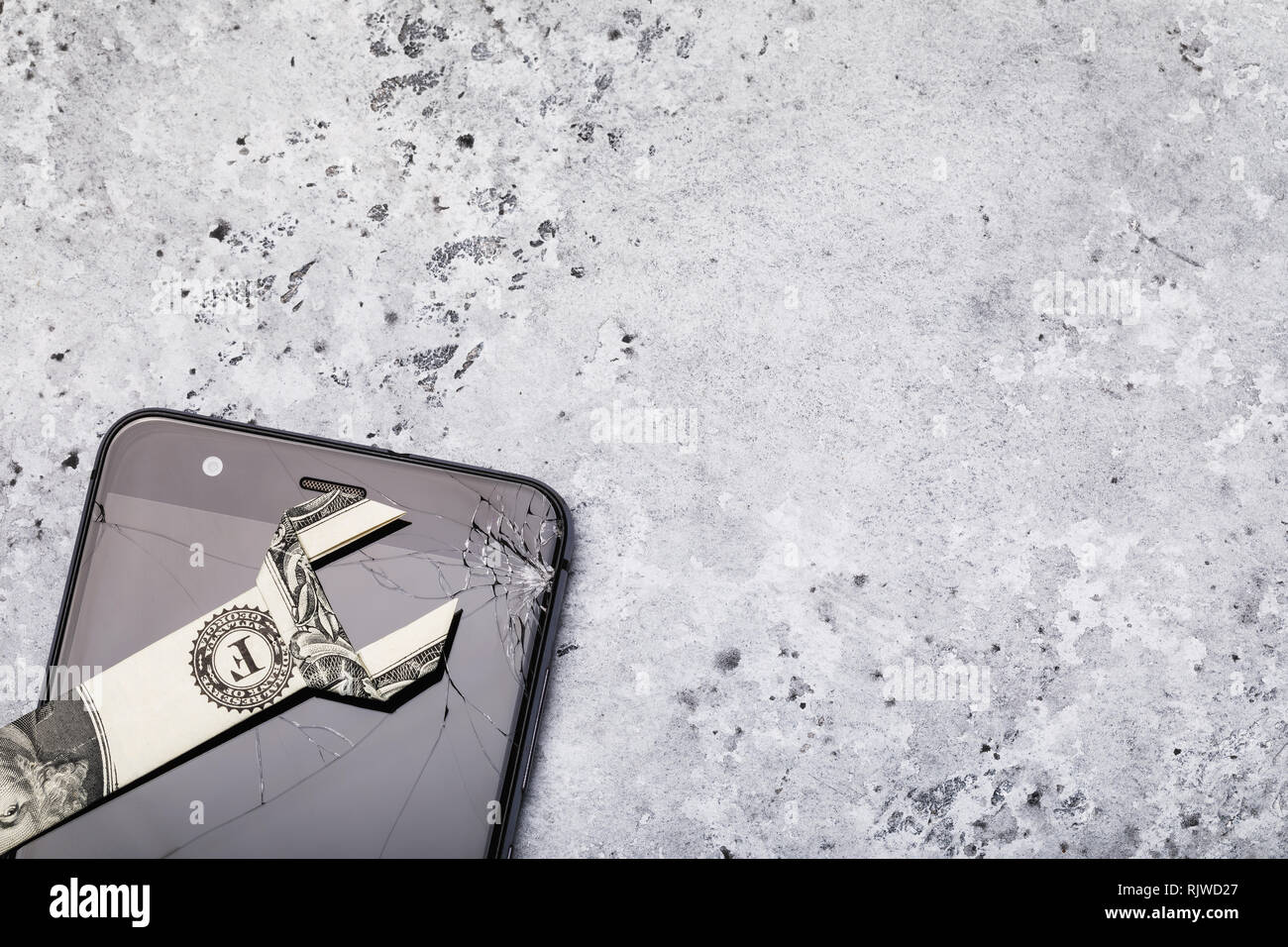 Broken glass on a cell phone screen with copy space. Concept on the cost of repairs Stock Photo
