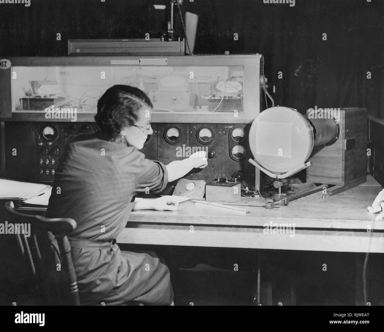 Television in the 1930s. A worker at GEC ( General Electric Company of Great Britain ) is testing the main television component, the cathode ray tube in the company's laboratories at Wembley. Much of the work on television at Wembley concentrated on the design of domestic receivers and the use of cathode ray tubes for use in these receivers. This intention was never realised because of the outbreak of the Second world war. All work on television was terminated, not to be re-started until the end of the war was in sight. Instead the industrial expertise focused on production of tubes suitable f Stock Photo