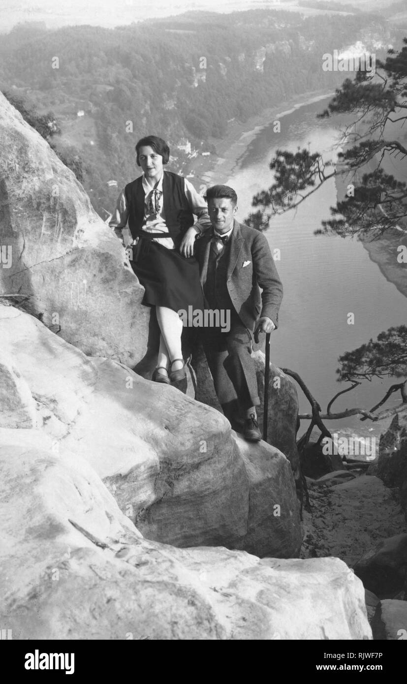 Couple hiking, rocks, ca. 1930s, Saxon Switzerland, Saxony, Germany Stock Photo