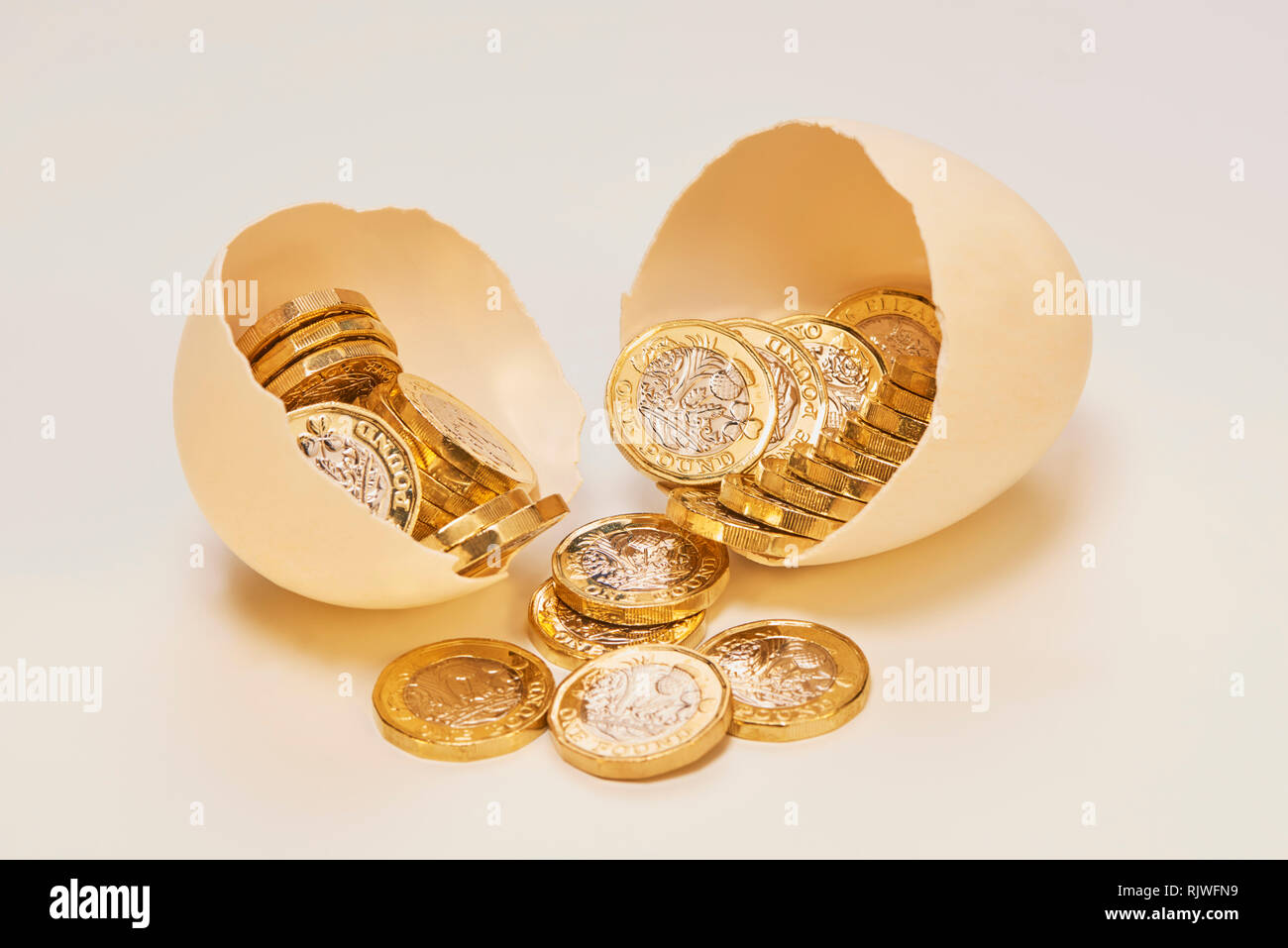 Nest Egg with Shinny Pound Coins Stock Photo