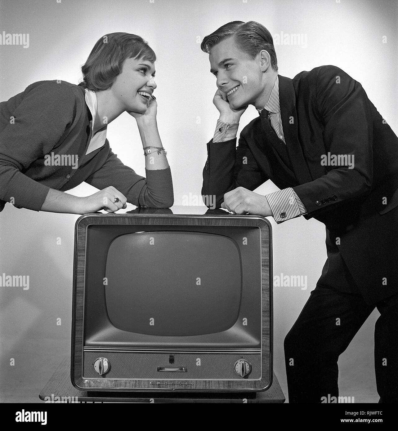 Television in the 1950s. A young couple is pictured beside a typical