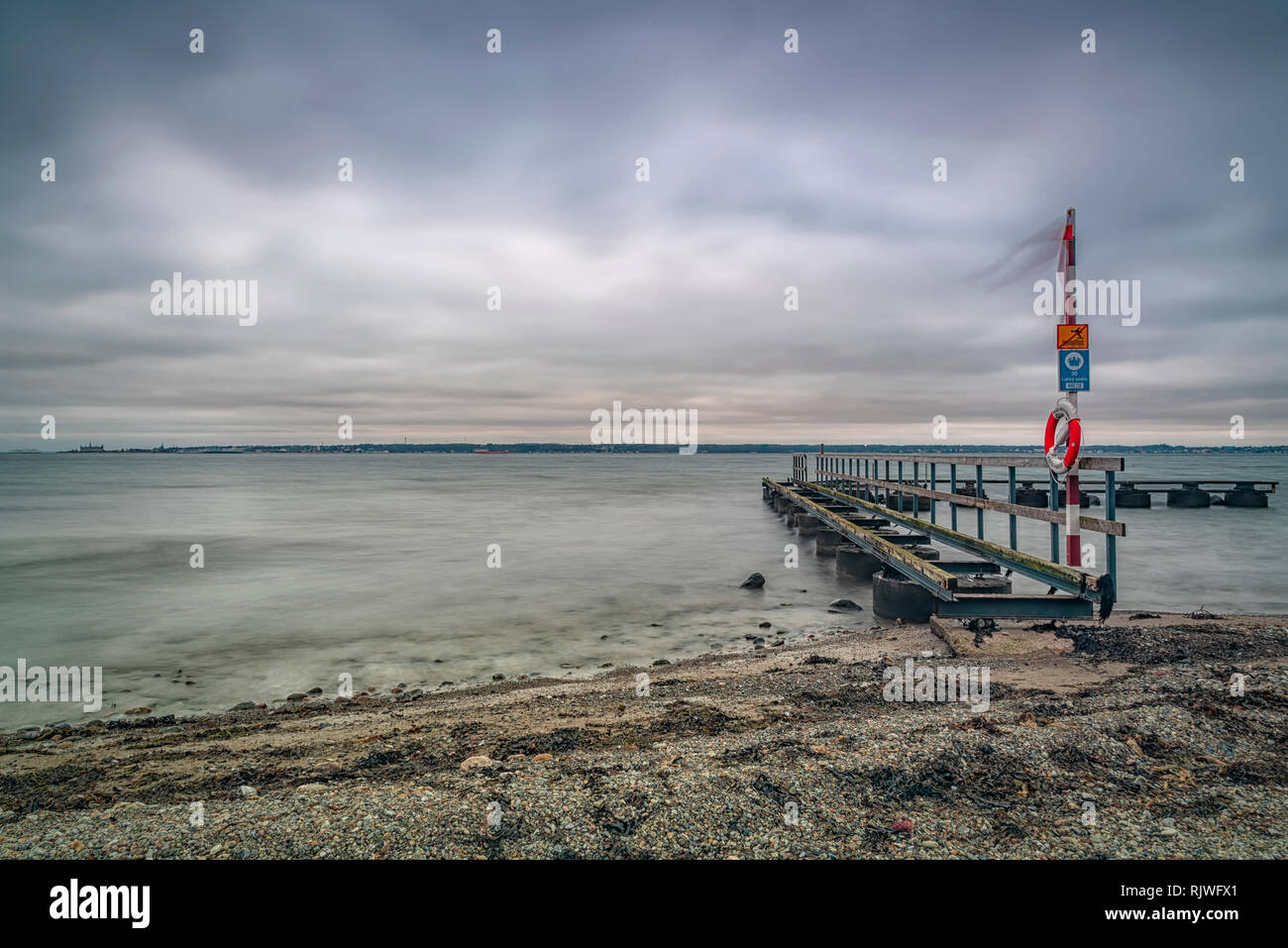 An old pier at Larod beach outside Helsingborg, overlooking the oresund towards Denmark. Stock Photo