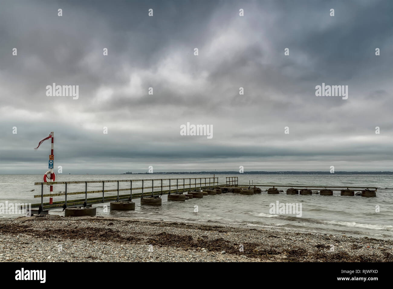 An old pier at Larod beach outside Helsingborg, overlooking the oresund towards Denmark. Stock Photo