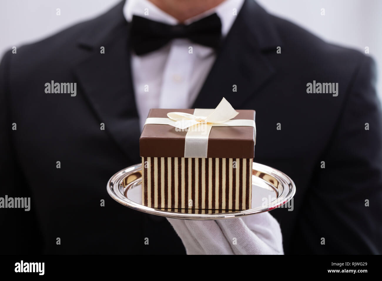 Waiter Box Close-up Of Male Waiter Wearing Bow Tie Presenting Small Gift Box Stock ...