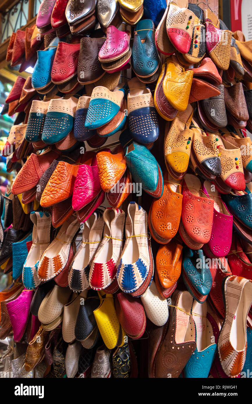 Colorful handmade leather slippers ( babouches ) on a market in Fez. traditional Moroccan shoes for sale in the souk (market) in Fes, Morocco Stock Photo