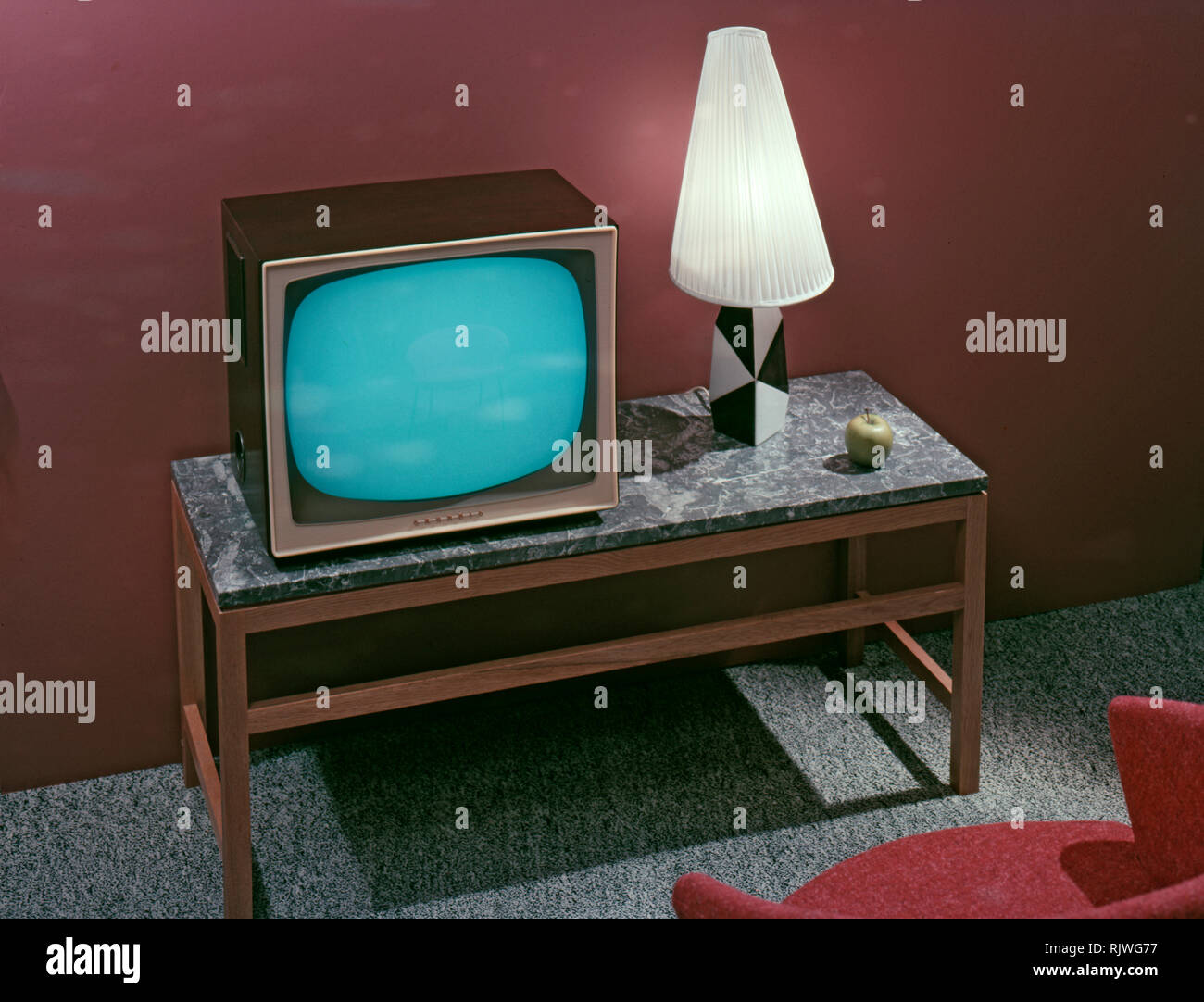 Television in the 1950s. A Grundig television set that was available for customers 1957. A typical 1950s design with a wooden case standing on thin legs. ref BV65-2 Stock Photo