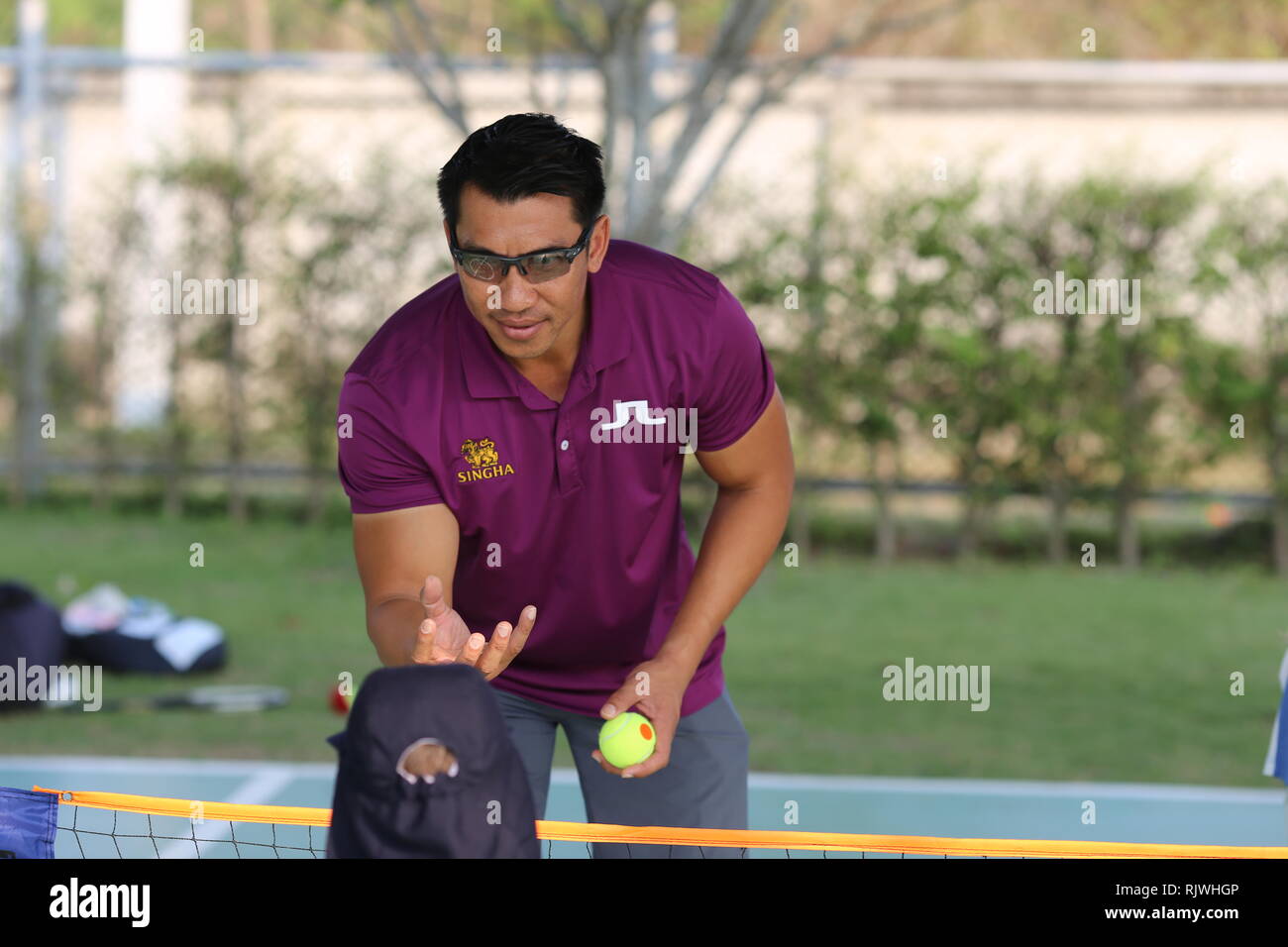 Internationally renowned Thai former tennis champion Paradorn Srichaphan coaches young students at an international school in Hua Hin. Stock Photo