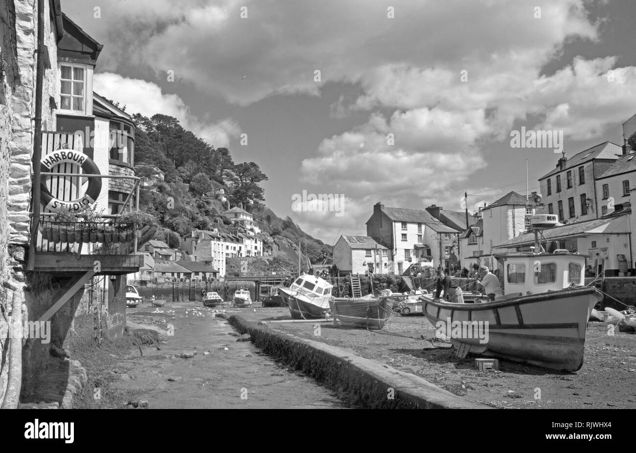 Boat maintenance at Polperro fishing harbour south east Cornwall Stock Photo