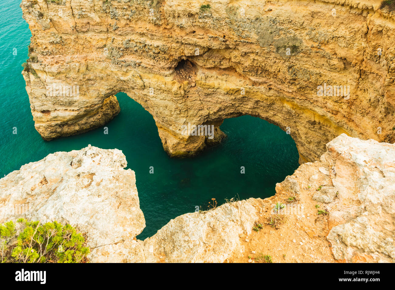 Natural arches underneath rugged cliffs, Praia da Marinha, Algarve, Portugal, Europe Stock Photo
