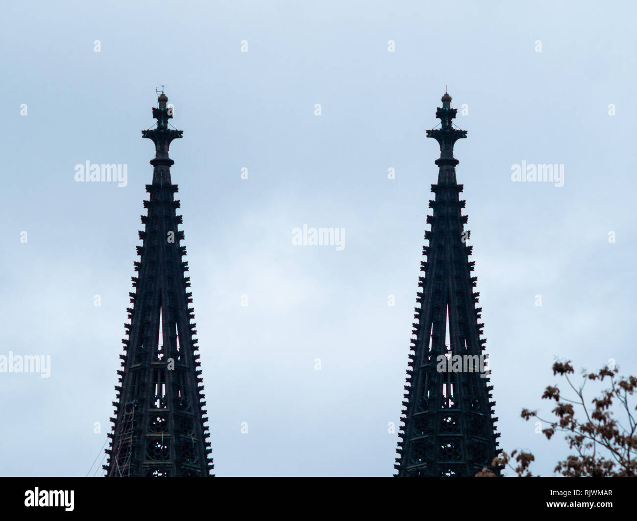 Minimalist shot of gothic Cologne Cathedral in Germany with scaffold against cloudy sky Stock Photo