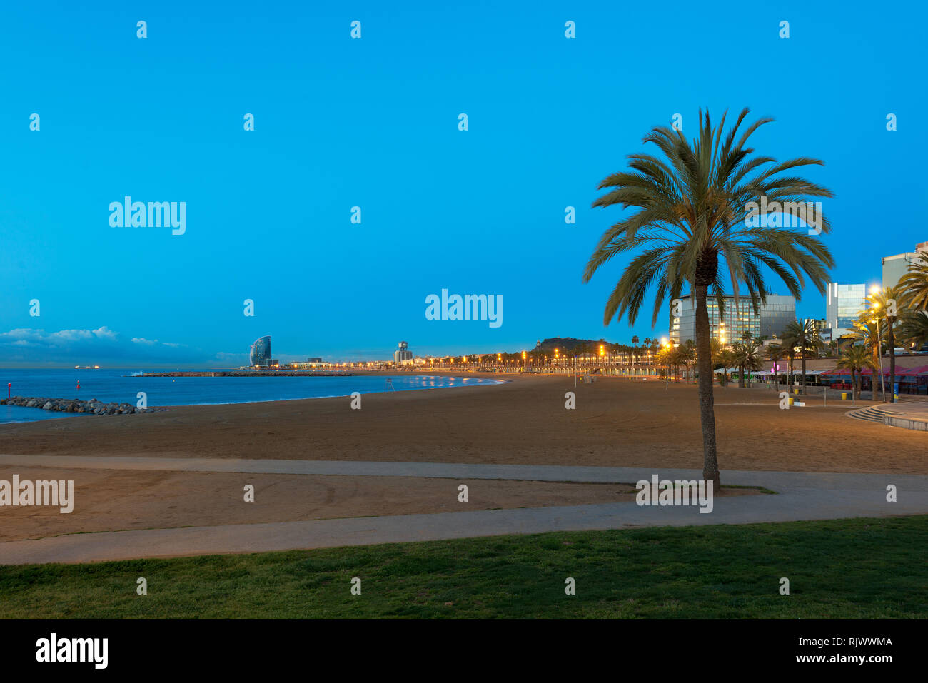 Night view of Barceloneta Beach in Barcelona with colorful sky at night. Seafront, beach,coast in Spain. Suburb of Barcelona, Catalonia Stock Photo