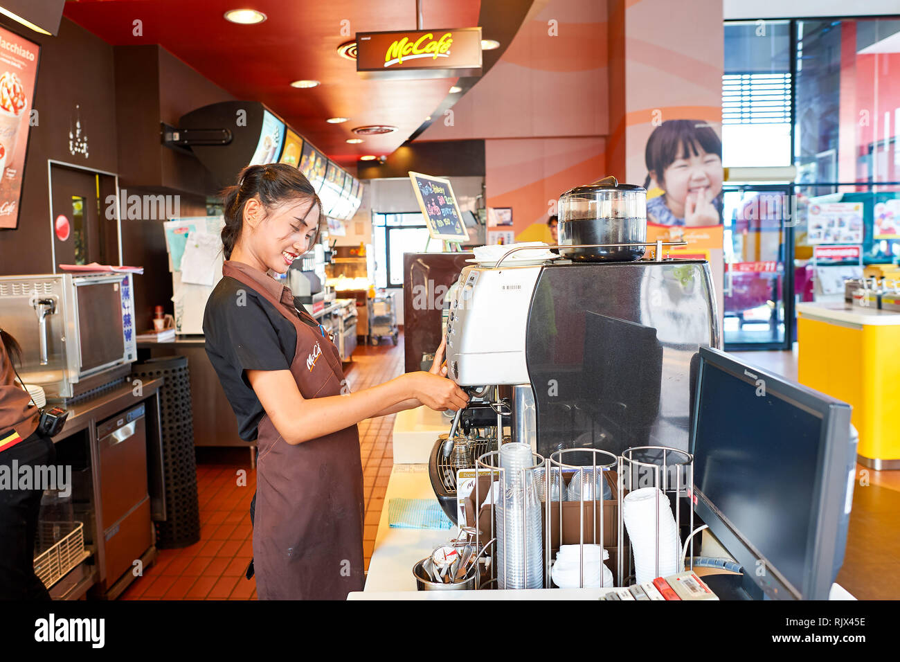 Mccafe Worker PATTAYA, THAILAND - FEBRUARY 21, 2016: worker at McCafe in Thailand ...