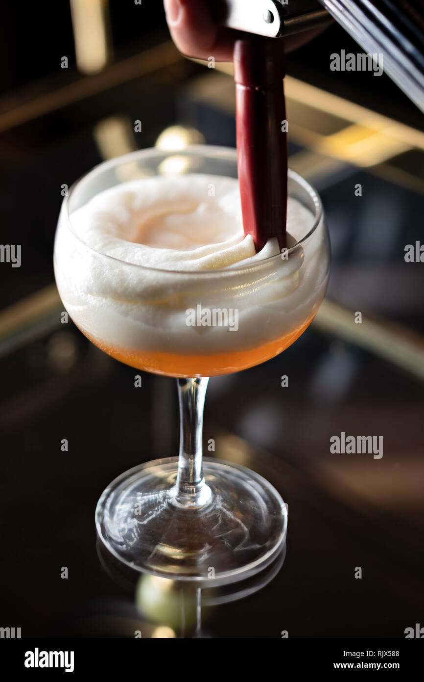 Adding the final touches on the cocktail Stock Photo - Alamy