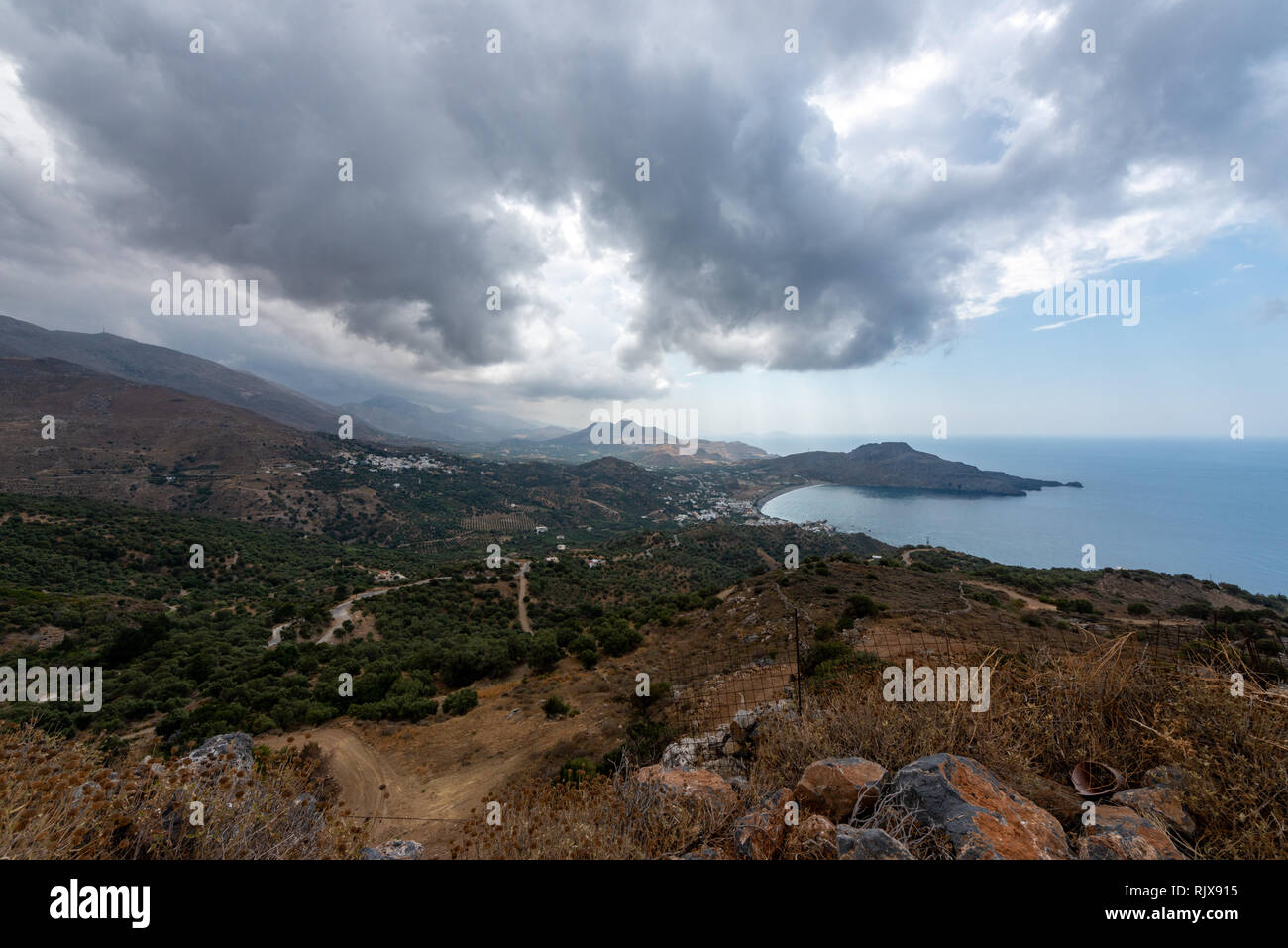 bay of Plakias underneath a sky with heavy rain clouds Stock Photo