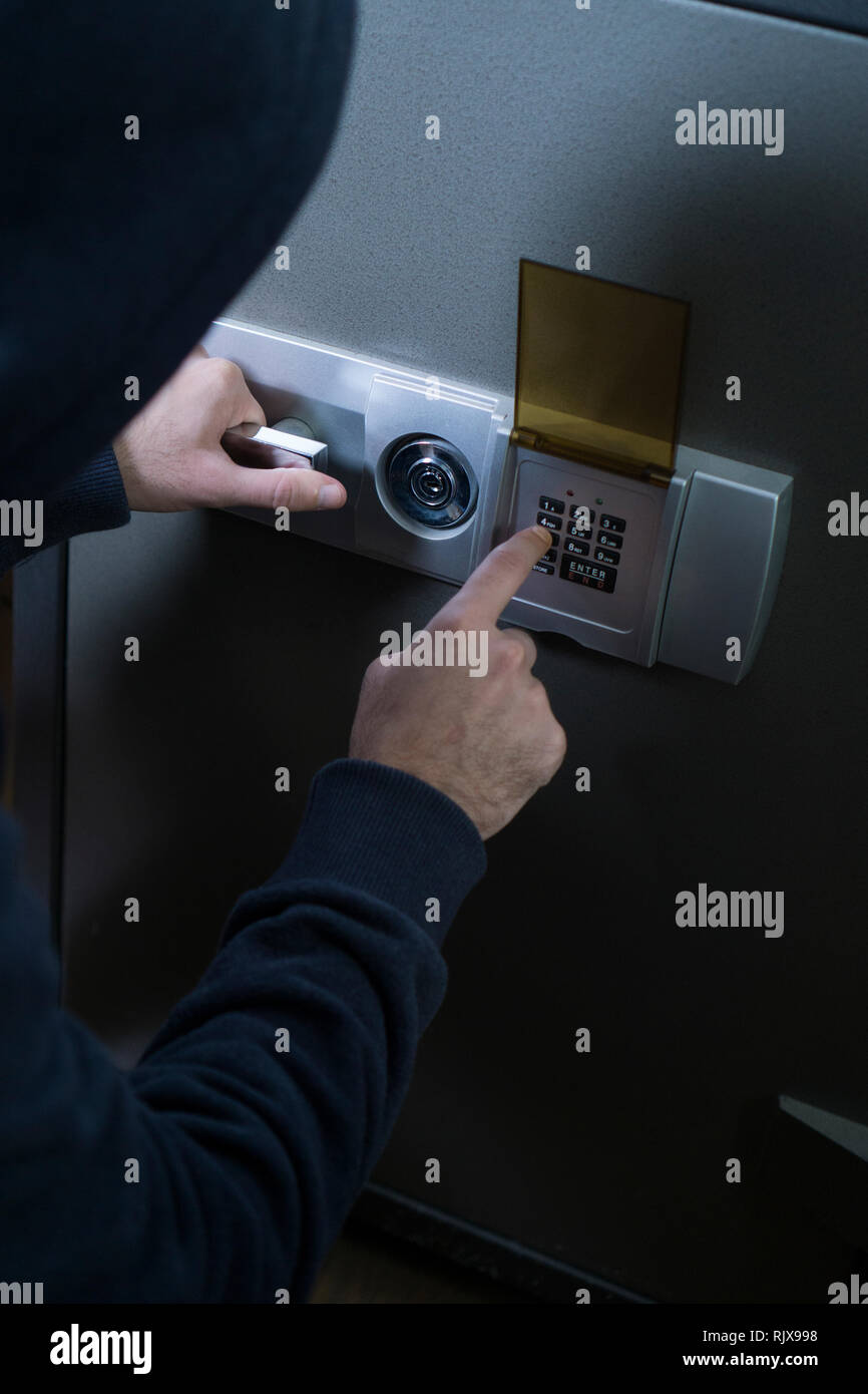 Criminal opening a safe for stealing Stock Photo Alamy