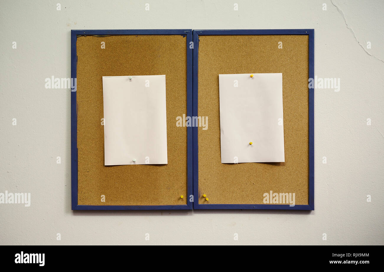 Simple composition, two frames of cork with blank white papers on wall. Stock Photo
