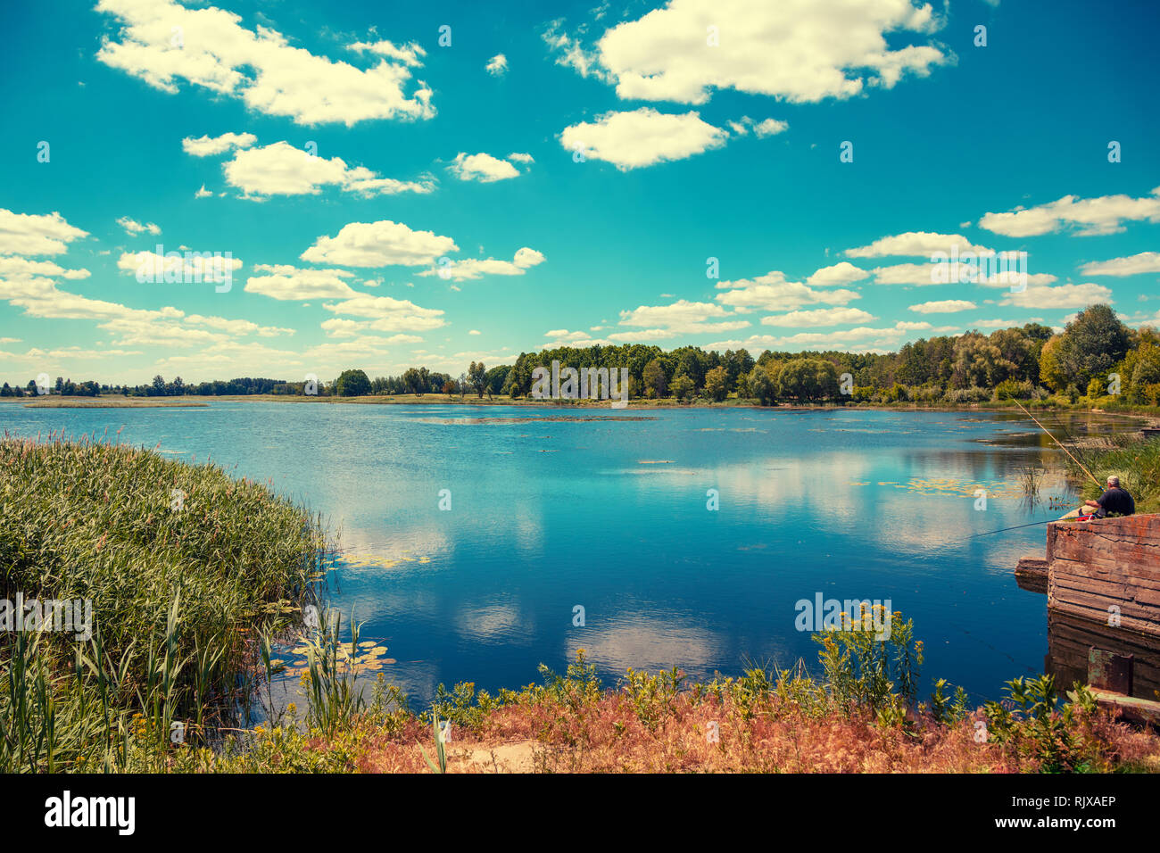 Beautiful lake with blue sky and white clouds on a sunny summer day ...