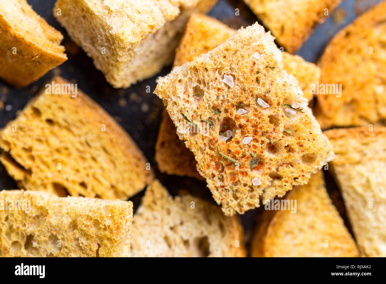 Crispy croutons with spices. Macro shot of roasted crouton Stock Photo