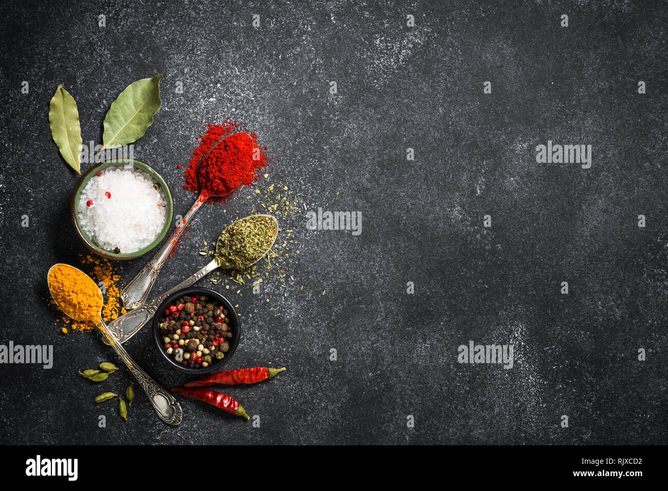 Spices, sea salt and pepper on black stone background Stock Photo Alamy