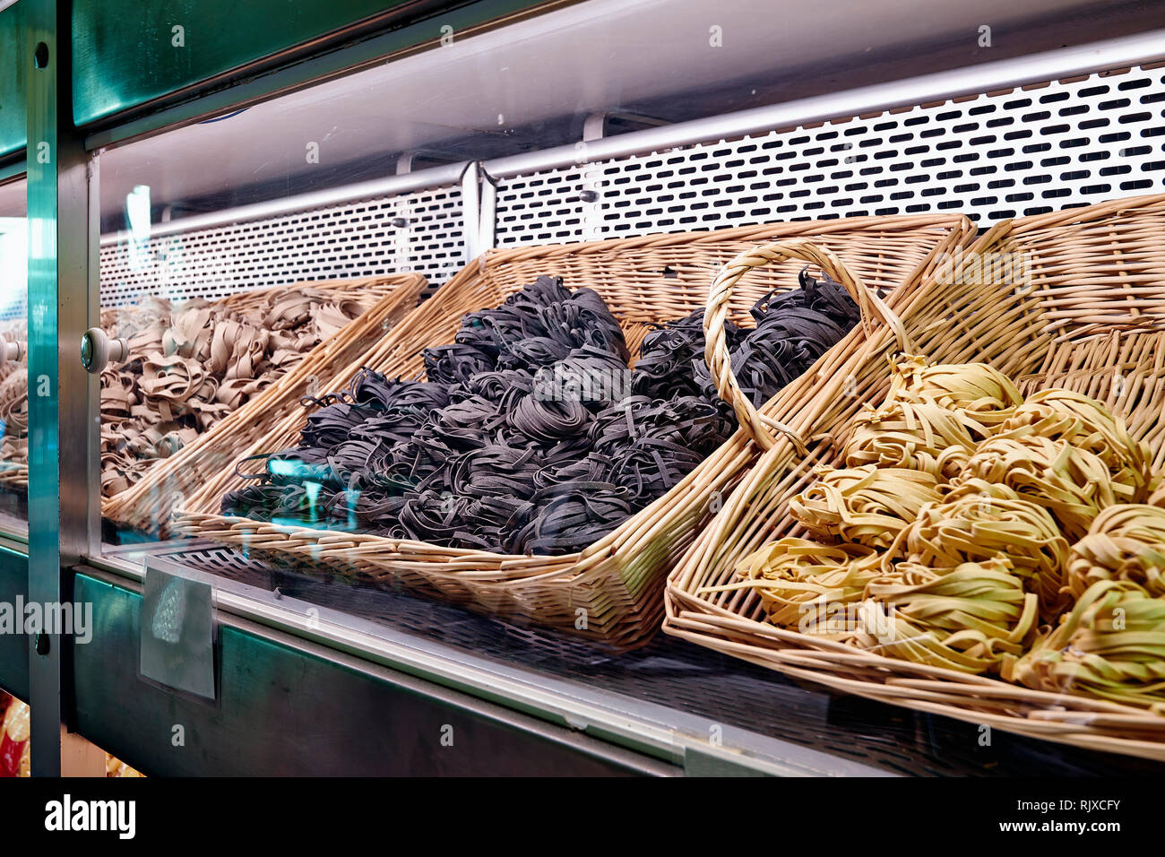 Different kind of pasta and wicker basket in store stock photo alamy