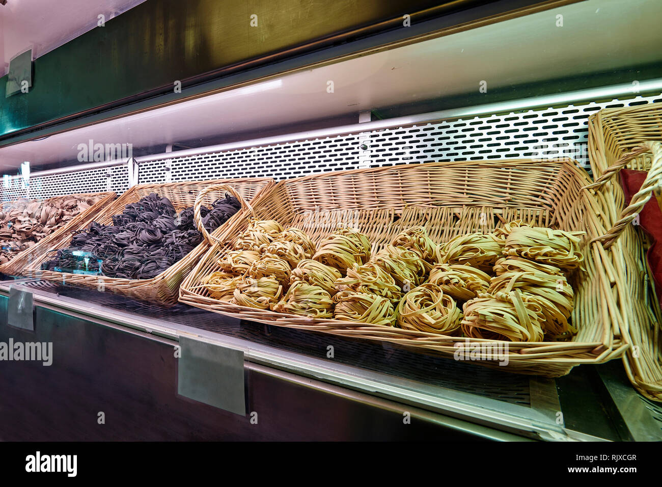 Different kind of pasta and wicker basket in store stock photo alamy
