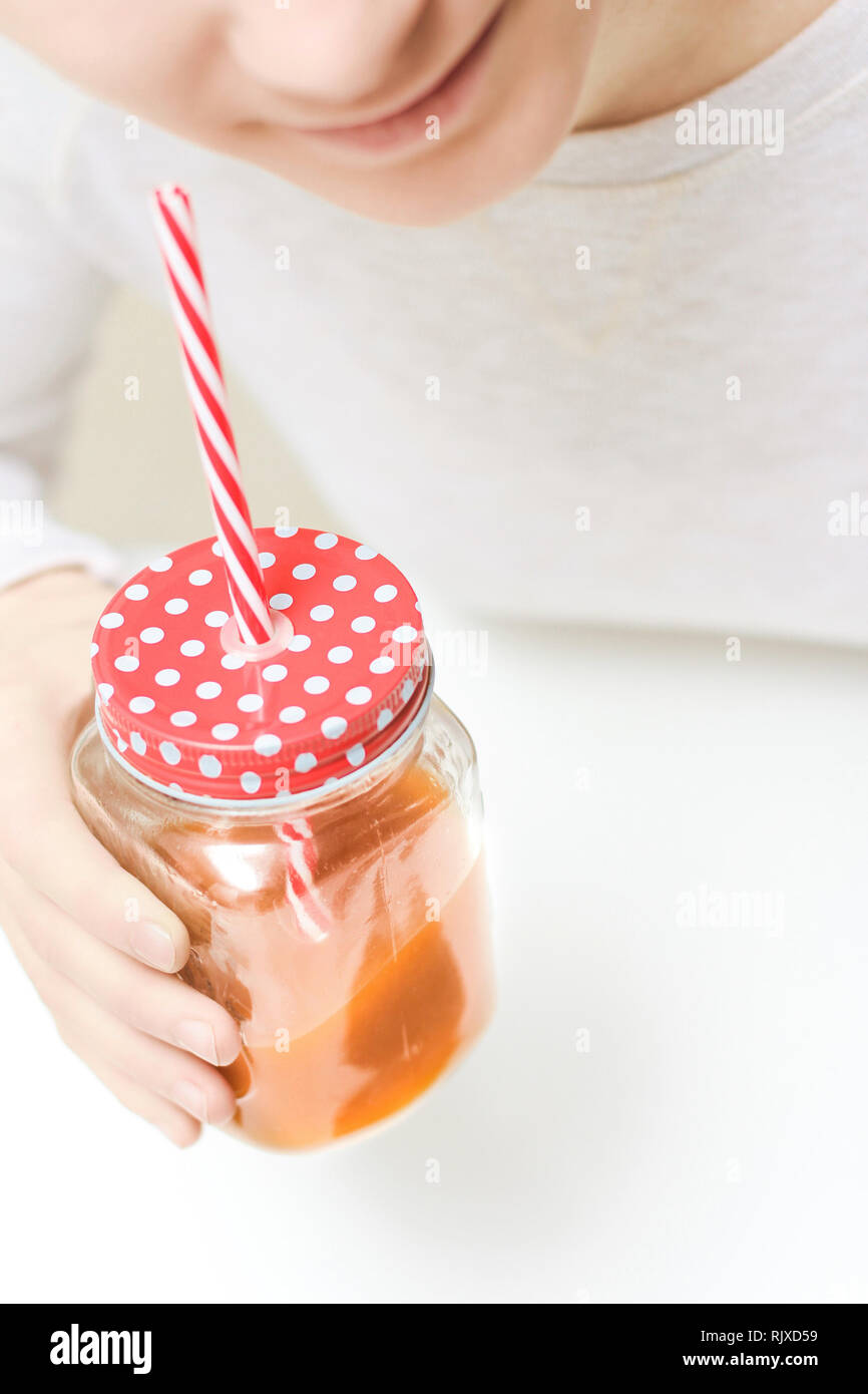 Woman drinking fruit juice at home Stock Photo