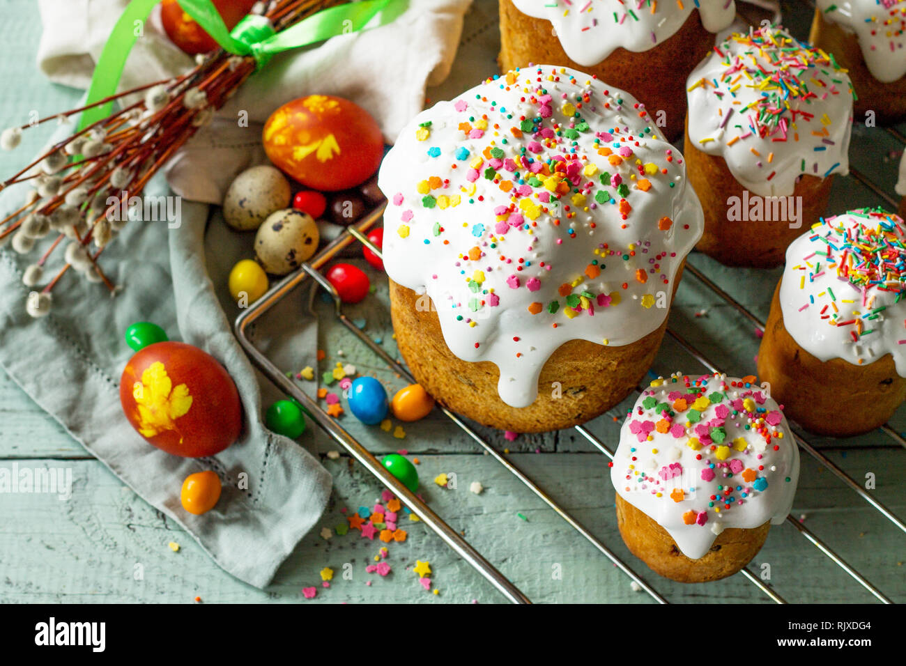 Springtime. Festive composition in rustic style. Easter cake and painted eggs on wooden table. Stock Photo