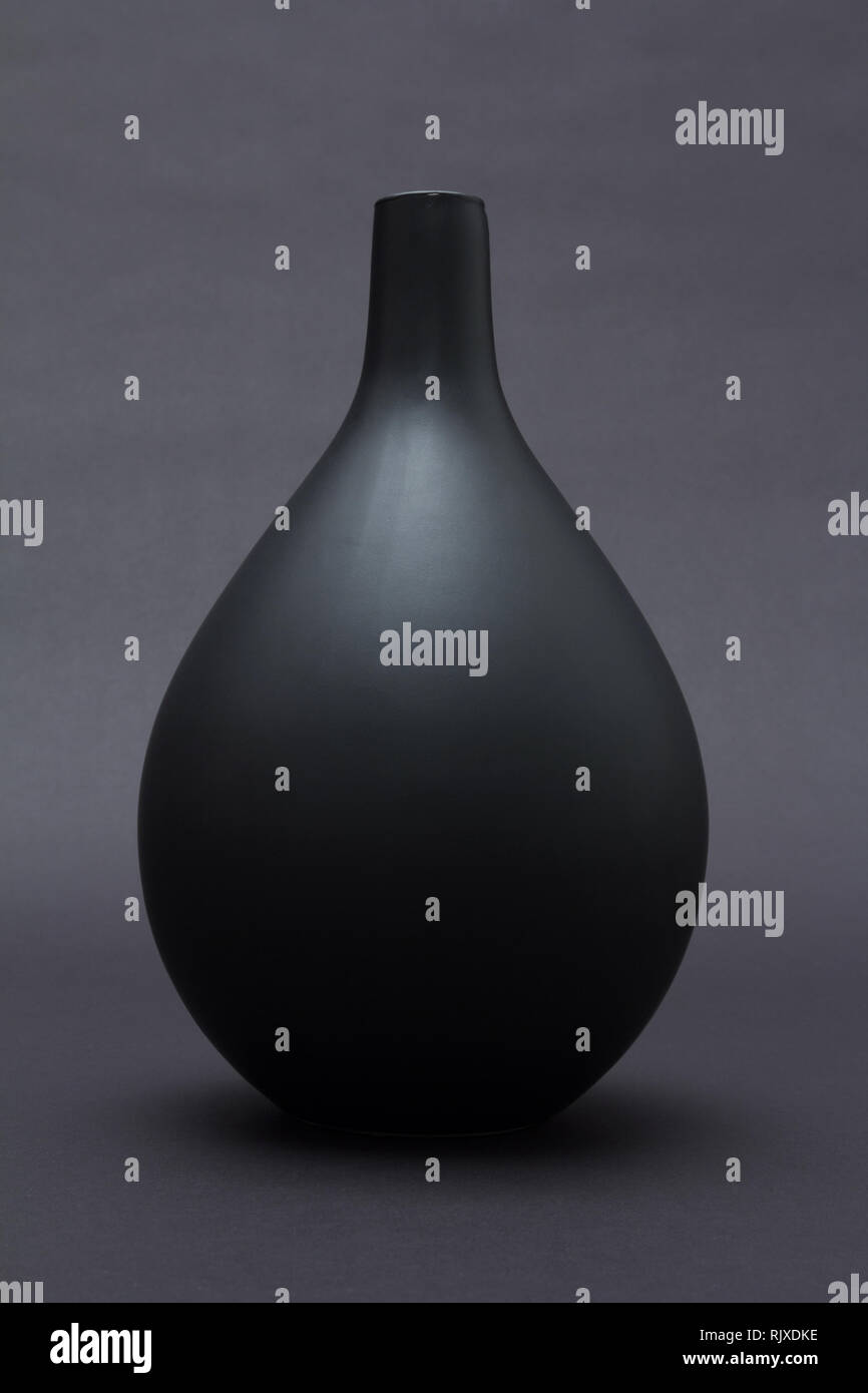 Matte black ceramic vase on black background isolated Stock Photo