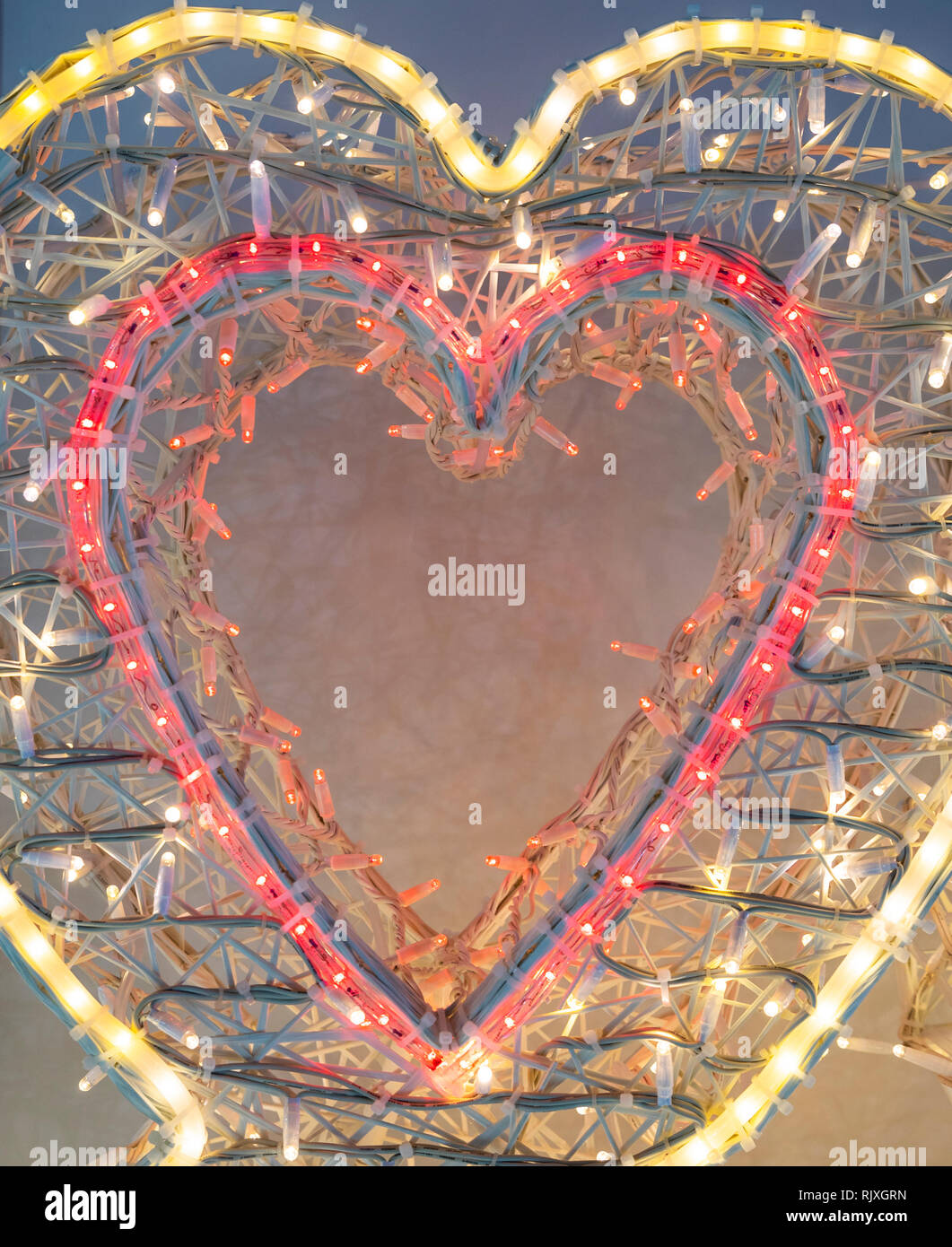 Illuminated heart shape made of electric lamps Stock Photo