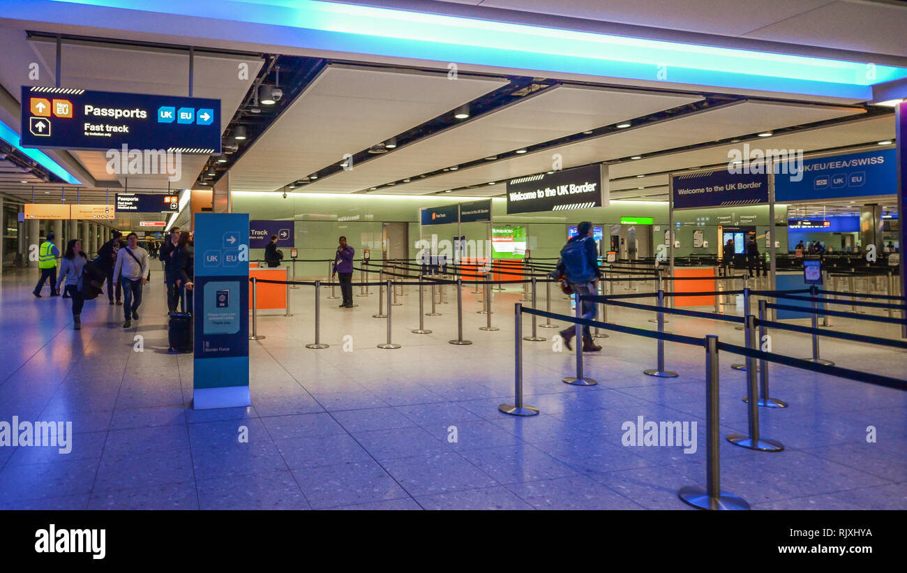 London Heathrow, UK, Feb 5, 2019: Passenger walks towards UK Border immigration passport control. Different queues for UK, EU and Non-EU passport hold Stock Photo