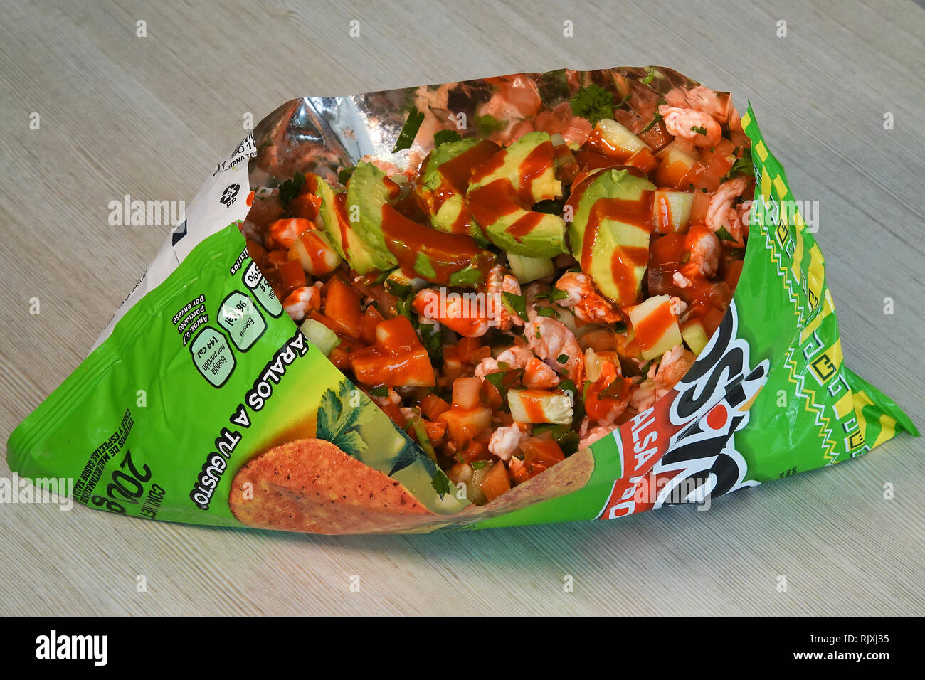A salsa quacamole appetizer mixed in a Tosito’s bag. Stock Photo