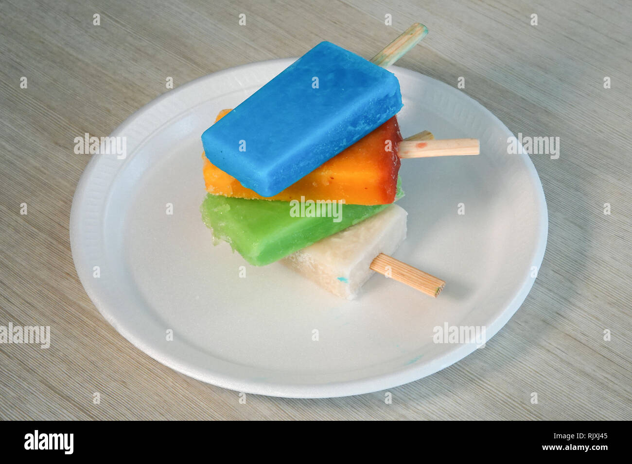 Colorful ice cream bars are stacked upon each other. Stock Photo