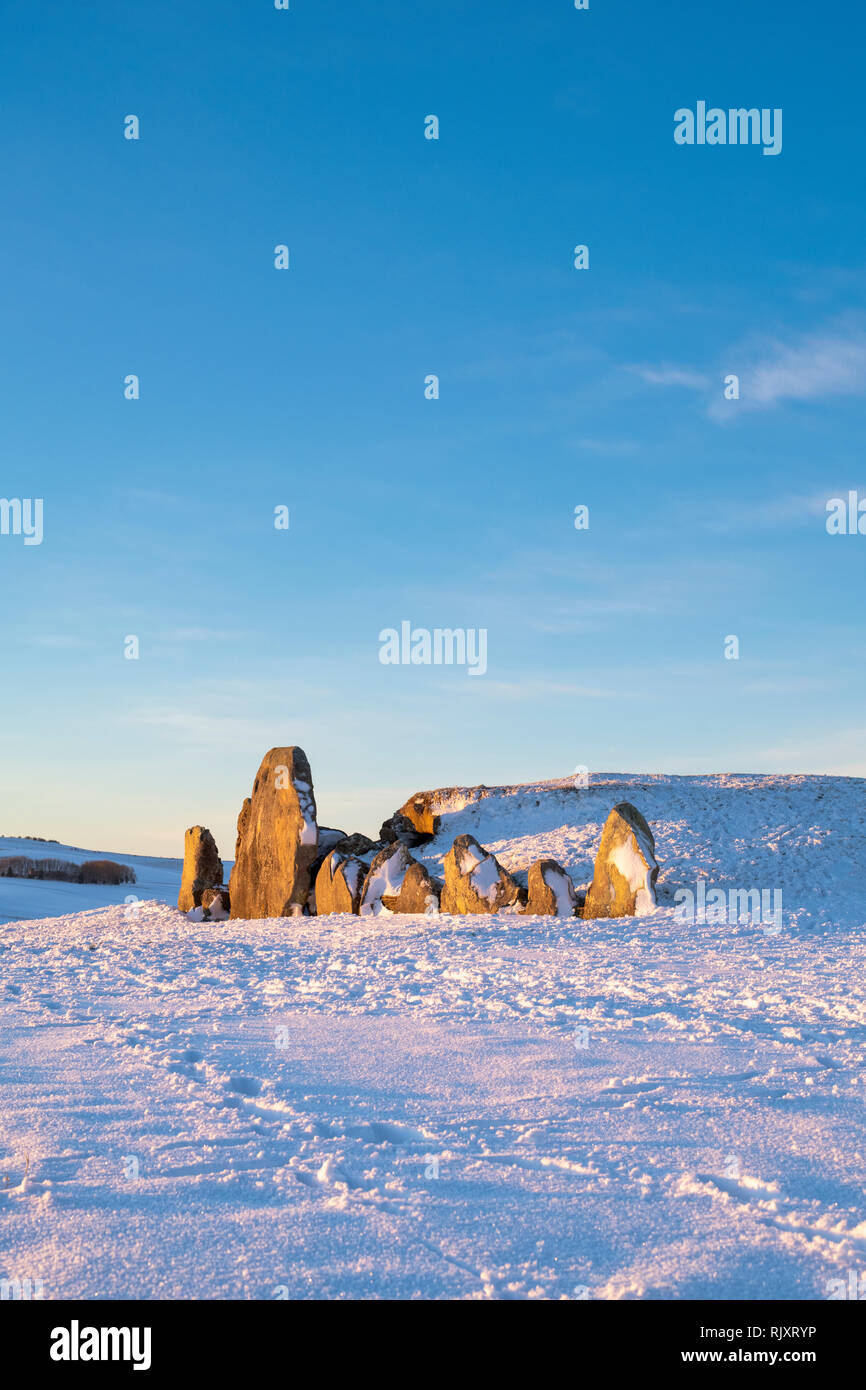 West Kennet Long Barrow in the winter snow at sunrise. Neolithic ...