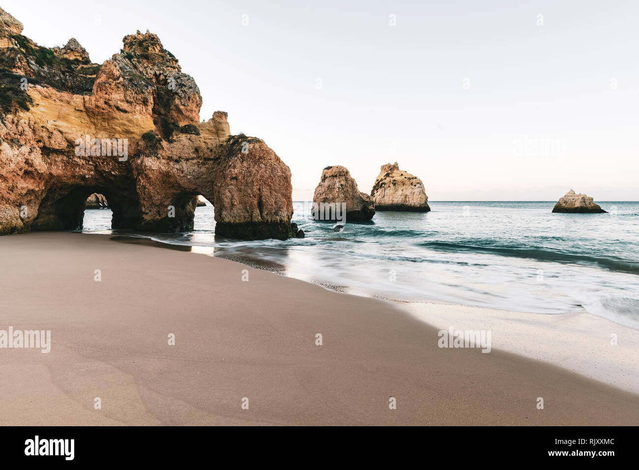 Cliffs and sea stacks at dusk, Alvor, Algarve, Portugal, Europe Stock Photo