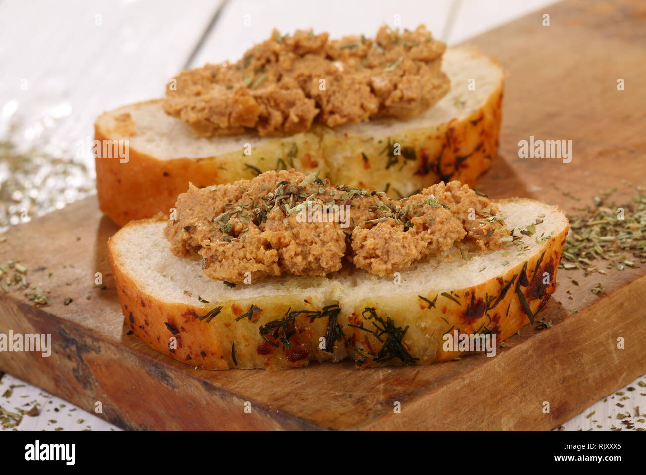 Norwegian cheese brunost on a white wooden table Stock Photo