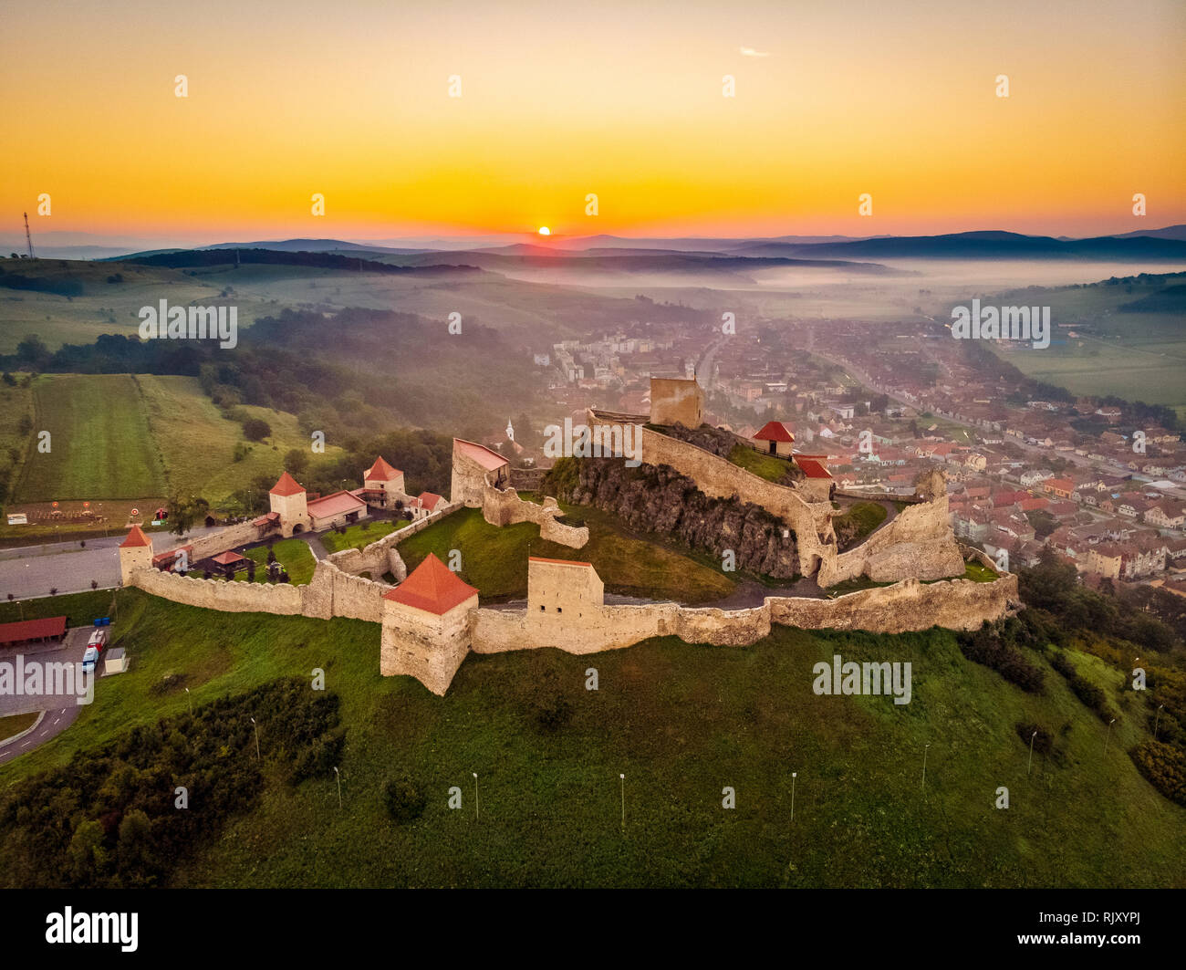 One of the symbols of Romania the Rupea Fortress in Transylvania. Aerial landscape at sunrise Stock Photo