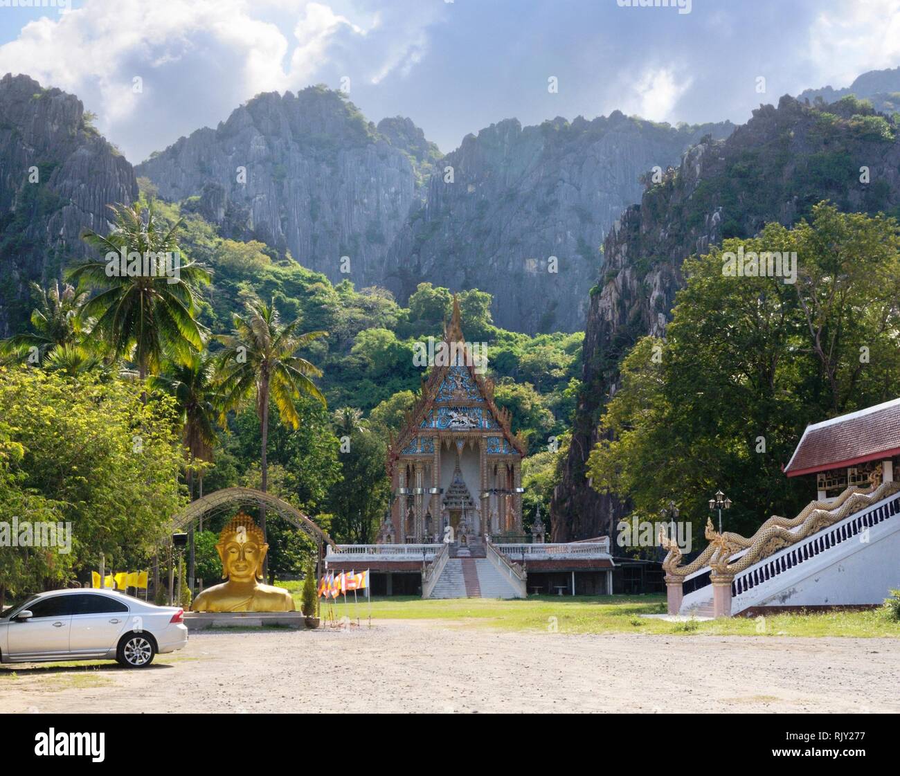 Wat Khao Daeng Thai Buddhist temple at the foot of the mountain range in Khao Sam Roi Yot National Park in Thailand Stock Photo