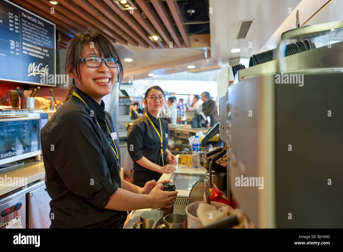 Mccafe Worker HONG KONG - MARCH 08, 2016: worker at McCafe in the Airport. McCafe is ...