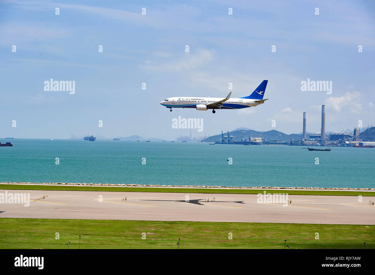 HONG KONG - JUNE 04, 2015: XiamenAir aircraft landing at Hong Kong airport. XiamenAir (formerly Xiamen Airlines) is the first privately owned airline  Stock Photo