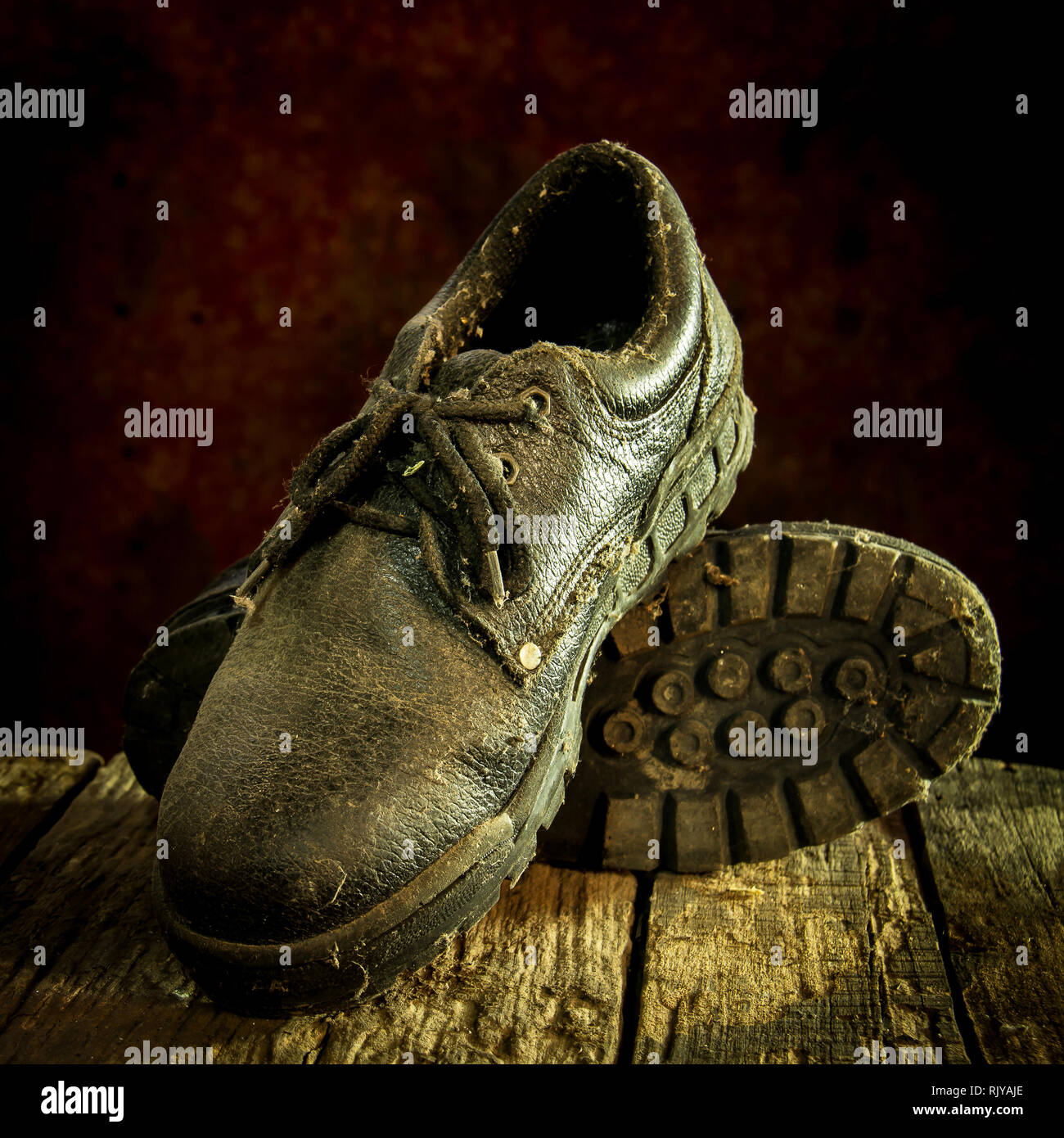 Still life with black leather shoes on wooden table Stock Photo