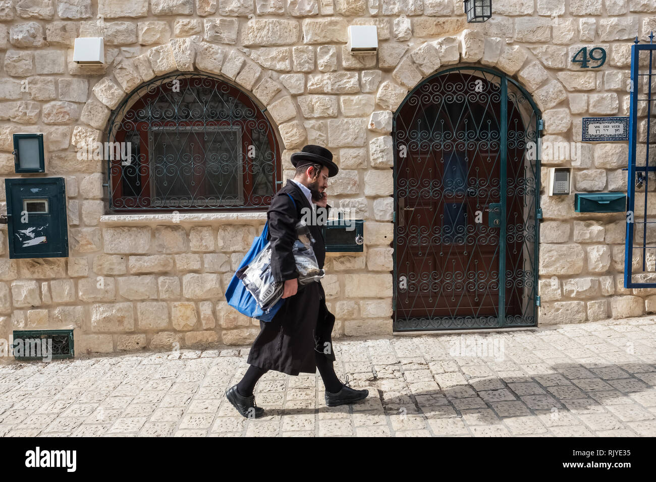 Tzfat, Israel - November 18, 2018: Orthodox jewish man walking on the street of Safed city. Tzfat has a reputation as the city of Kabbalah. Stock Photo