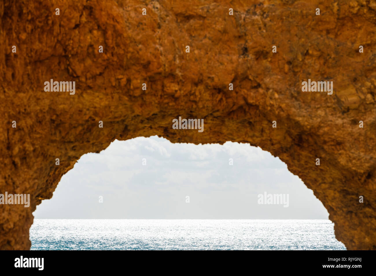 Looking through natural arch in cliff, Alvor, Algarve, Portugal, Europe Stock Photo