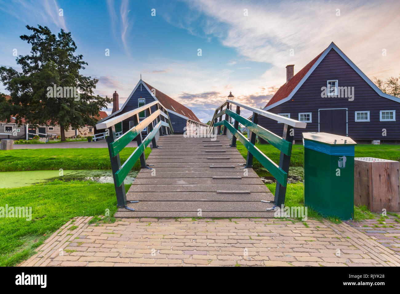 Typically traditional Dutch house, historical architecture and bridge over water at the Zaanse Schans, Amsterdam. Attractive landmark. Stock Photo