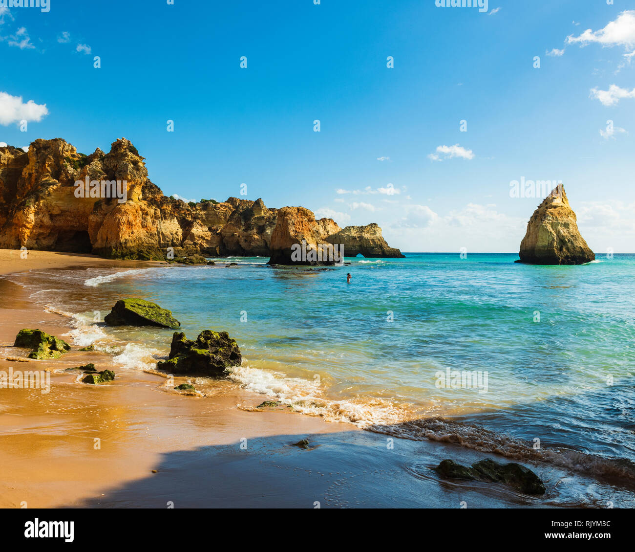 Distant view of large sea stacks in blue sea, Alvor, Algarve, Portugal, Europe Stock Photo