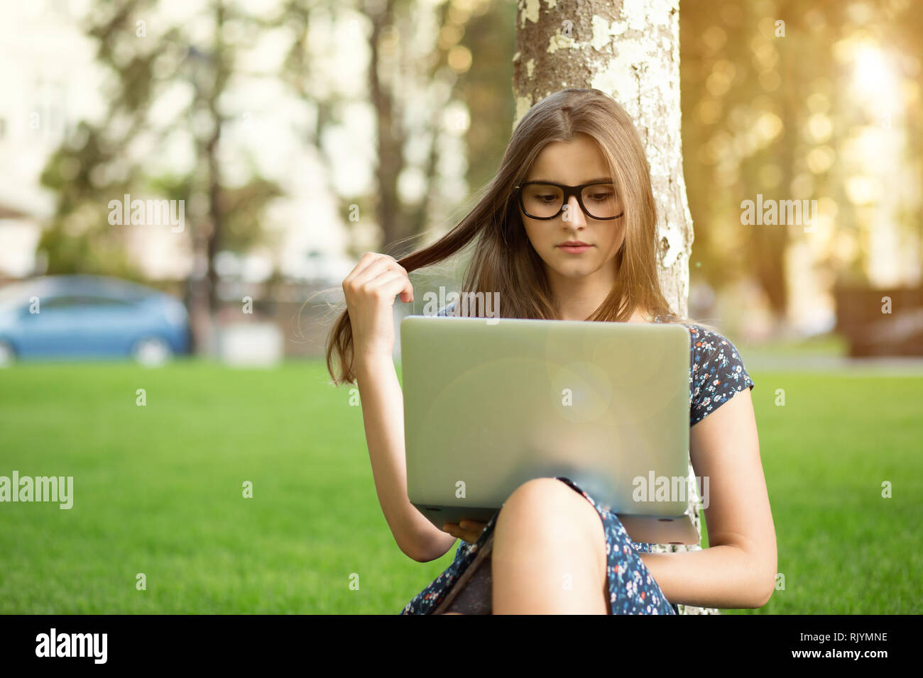 teenager using a laptop outside Stock Photo Alamy