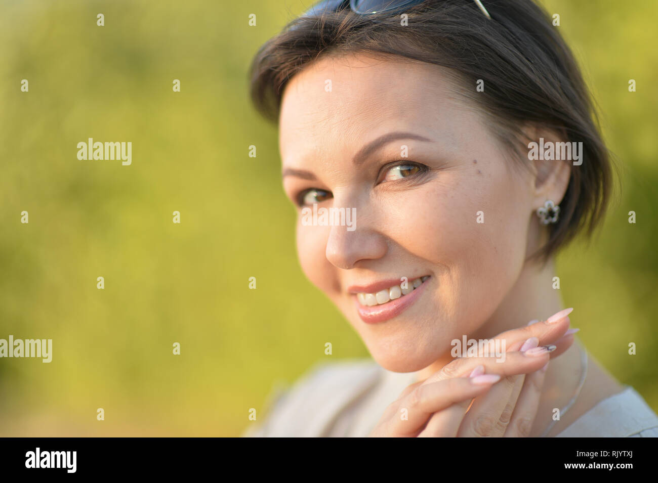 Beautiful young woman resting in summer park Stock Photo - Alamy